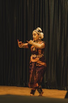 A Bharatanatyam dancer performs a traditional dance on stage in Guruvayur, India.